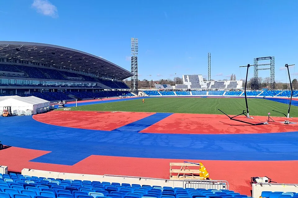 The blue track and seating areas of Alexander Stadium in Birmingham.